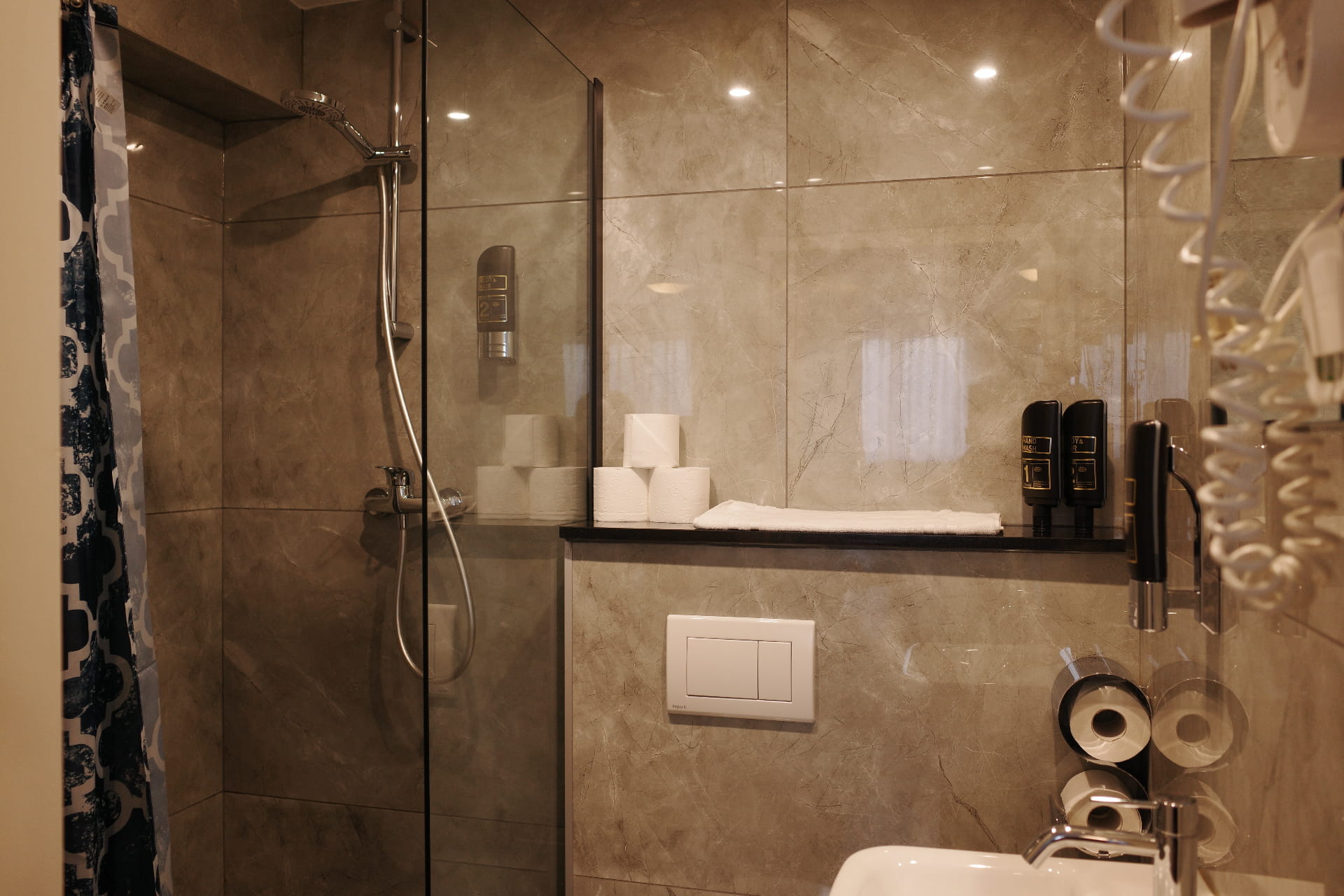 Private bathroom with marble shower and toiletries